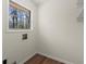 This laundry room has hardwood-style floors and a window that lets in natural light at 6175 Knights Ln, Douglasville, GA 30135