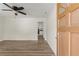 Bright, open-concept living space showcasing new wood-look floors and a ceiling fan at 6175 Knights Ln, Douglasville, GA 30135