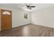Bright, open-concept living space showcasing new wood-look floors and a ceiling fan at 6175 Knights Ln, Douglasville, GA 30135