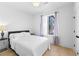 A clean bedroom with a white bed, wood floors, and natural light at 699 Pryor Sw St # 4, Atlanta, GA 30315