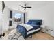 A nicely staged bedroom with a blue bed and a large window at 699 Pryor Sw St # 4, Atlanta, GA 30315