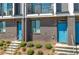 Close-up of modern townhome entrances with vibrant blue doors, brick accents, and well-maintained landscaping at 699 Pryor Sw St # 4, Atlanta, GA 30315