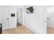 Hallway with wood floors, white trim, and a door to a bathroom at 699 Pryor Sw St # 4, Atlanta, GA 30315