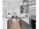 Bright open kitchen with gray cabinets, stainless steel appliances, quartz countertops, and hardwood floors at 699 Pryor Sw St # 4, Atlanta, GA 30315