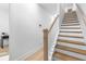 Bright staircase featuring hardwood steps, a white banister, and fresh, neutral paint at 699 Pryor Sw St # 4, Atlanta, GA 30315
