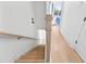 Bright staircase featuring light wood steps, white walls, and a modern handrail at 699 Pryor Sw St # 4, Atlanta, GA 30315