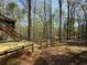 Wooden deck and staircase overlooks a wooded backyard at 802 Crow View Ct, Woodstock, GA 30189