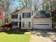 Two-story home featuring an attached garage, a well-maintained lawn, and a classic design at 802 Crow View Ct, Woodstock, GA 30189
