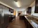 Modern kitchen featuring stainless steel appliances, granite countertops, and dark wood cabinets at 802 Crow View Ct, Woodstock, GA 30189