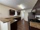 Well-lit kitchen boasts granite countertops, stainless steel appliances, and dark wood cabinets at 802 Crow View Ct, Woodstock, GA 30189