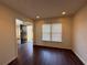 Bright living room with dark wood floors, neutral paint, and natural light from a large window at 802 Crow View Ct, Woodstock, GA 30189