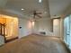 Living room with recessed lighting, fan, built in shelving, and french doors at 802 Crow View Ct, Woodstock, GA 30189