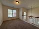 Well-lit loft area with large windows offering a view of the outdoors at 802 Crow View Ct, Woodstock, GA 30189