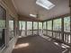 Inviting sunroom with skylights, windows, and a ceiling fan for natural light and ventilation at 802 Crow View Ct, Woodstock, GA 30189