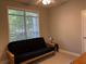 Comfortable room featuring a futon sofa and natural light from a large window at 1106 Stratford Commons, Decatur, GA 30033