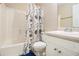 Bathroom featuring a tub with shower, toilet, sink and vanity with floral shower curtain at 165 Gingercake Ct, Fayetteville, GA 30214