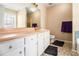 Bathroom featuring blue tile accents, a large mirror, and stylish cabinets at 165 Gingercake Ct, Fayetteville, GA 30214