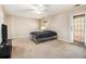 Neutral bedroom with a ceiling fan, walkout door, and ample natural light at 165 Gingercake Ct, Fayetteville, GA 30214
