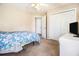 Bedroom with blue floral bedding, neutral walls, closet, and a ceiling fan at 165 Gingercake Ct, Fayetteville, GA 30214