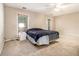 Bright bedroom featuring neutral walls, large window, and a door to the backyard at 165 Gingercake Ct, Fayetteville, GA 30214