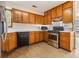 Kitchen features stainless steel appliances, light wood cabinets and a view to the outdoors at 165 Gingercake Ct, Fayetteville, GA 30214