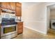 Kitchen with stove, washer/dryer next door and light wood cabinets at 165 Gingercake Ct, Fayetteville, GA 30214