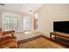 Bright living room with large windows, comfortable seating, and a view of the entry and adjacent rooms at 165 Gingercake Ct, Fayetteville, GA 30214