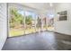 Sunroom with white siding and a concrete floor with views of the backyard at 165 Gingercake Ct, Fayetteville, GA 30214
