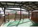 Covered back porch with dark wood trim, view to backyard and ceiling fan at 1852 E Farris Ave, Atlanta, GA 30344