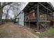 View of the backyard and covered porch, with dark wood trim and stairs at 1852 E Farris Ave, Atlanta, GA 30344