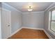 Bright bedroom featuring wood-look floors, neutral paint, and a large window at 1852 E Farris Ave, Atlanta, GA 30344