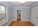 Bright bedroom featuring wood-look floors, neutral paint, and a large window at 1852 E Farris Ave, Atlanta, GA 30344
