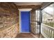 Covered front porch featuring stone facade, white railing and a blue door at 1852 E Farris Ave, Atlanta, GA 30344