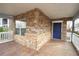 Covered front porch featuring stone facade, white railing and a blue door at 1852 E Farris Ave, Atlanta, GA 30344