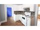 Kitchen featuring white cabinets, mosaic backsplash, tile floors, and stove appliance at 1852 E Farris Ave, Atlanta, GA 30344