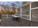 A beautifully screened back porch features a dark wood table and seating for elegant outdoor dining at 803 Courtenay Ne Dr, Atlanta, GA 30306