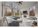 Relax in the screened porch with a fireplace, TV and white furniture with views of the backyard at 803 Courtenay Ne Dr, Atlanta, GA 30306