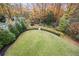 This serene backyard has a lush green lawn, colorful fall foliage, and a playset at 803 Courtenay Ne Dr, Atlanta, GA 30306