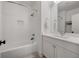 Clean bathroom featuring updated vanity and fixtures with a tiled shower and bath at 803 Courtenay Ne Dr, Atlanta, GA 30306