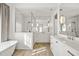 Modern bathroom featuring a soaking tub, walk-in shower, dual sinks and lots of natural light at 803 Courtenay Ne Dr, Atlanta, GA 30306