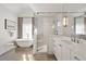 Modern bathroom featuring a soaking tub, walk-in shower, dual sinks and lots of natural light at 803 Courtenay Ne Dr, Atlanta, GA 30306