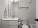 Modern bathroom featuring white vanity, matching toilet, and updated tiled shower with new fixtures at 803 Courtenay Ne Dr, Atlanta, GA 30306