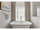 Bright bathroom featuring a freestanding tub, quartz counters, and modern fixtures and finishes at 803 Courtenay Ne Dr, Atlanta, GA 30306
