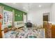 Bright Bedroom with a colorful rug, modern furniture, and an accent green wall with stylish decor at 803 Courtenay Ne Dr, Atlanta, GA 30306
