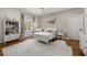 Bright bedroom showcasing hardwood floors, soft rug, and a decorative art piece on the wall at 803 Courtenay Ne Dr, Atlanta, GA 30306