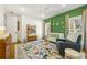 Bright Bedroom featuring a colorful rug, green accent wall with animal art, and a comfortable gray armchair at 803 Courtenay Ne Dr, Atlanta, GA 30306
