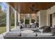 Relax in this covered patio with column supports, a ceiling fan, and outdoor seating at 803 Courtenay Ne Dr, Atlanta, GA 30306