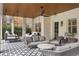 This large covered patio with tile flooring and porch swings is perfect for outdoor living at 803 Courtenay Ne Dr, Atlanta, GA 30306