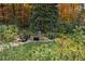 Relax by this tranquil backyard firepit surrounded by mature trees and manicured landscaping at 803 Courtenay Ne Dr, Atlanta, GA 30306