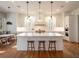 Modern kitchen with white cabinetry, a large island with seating, and stylish pendant lighting at 803 Courtenay Ne Dr, Atlanta, GA 30306